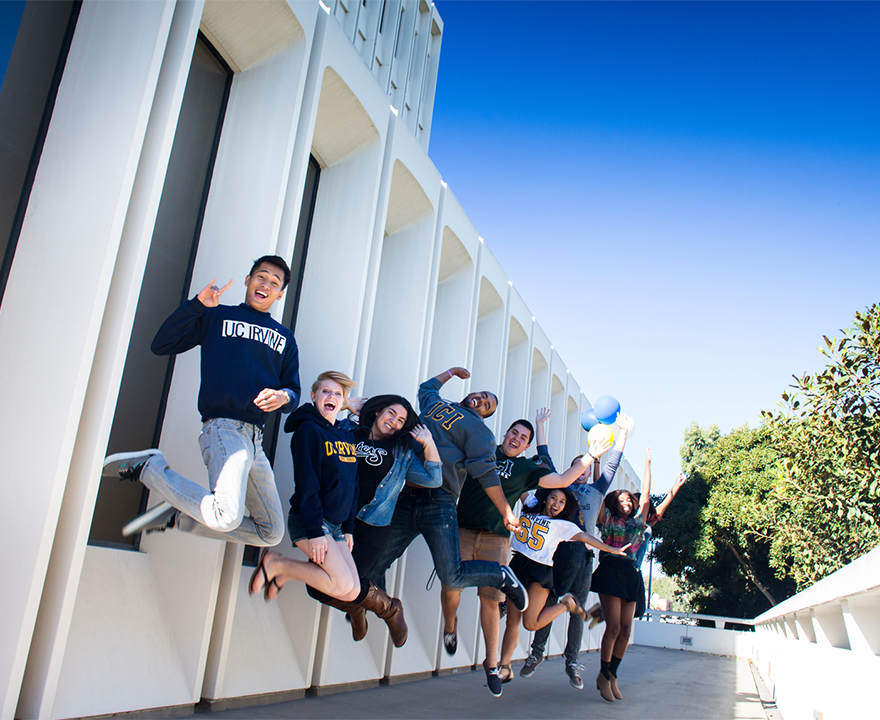 undergraduate students jumping for joy