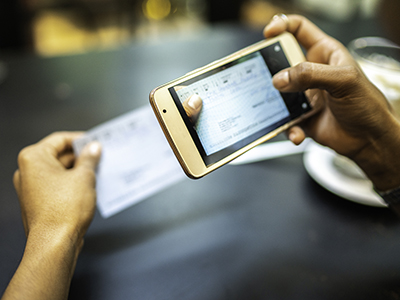 Person depositing a check through mobile device